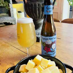 Coconut & Vanilla beer bottle and glass with cheese