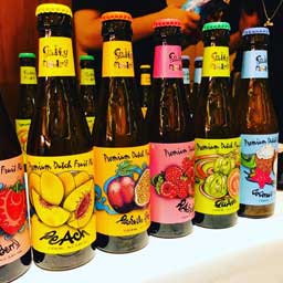 Five bottles of beer, each a different fruit flavour