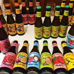 Multiple fruit beer bottles, some standing some laying horizonal