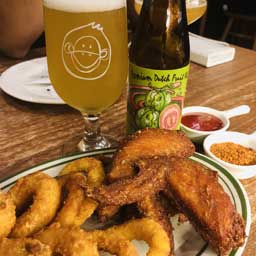 Guava beer bottle and glass with fried food