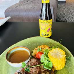 Peach beer bottle and glass with cooked sweetcorn