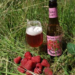 Raspberry beer bottle and glass with raspberries
