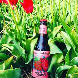Strawberry beer bottle and red flowers