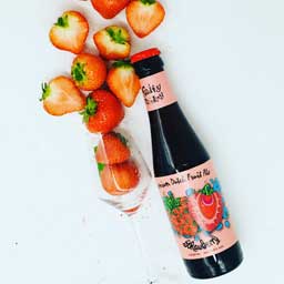 Strawberry beer bottle and strawberries