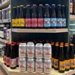 Bottles and cans of beer on Slijterij van Oeveren shelves