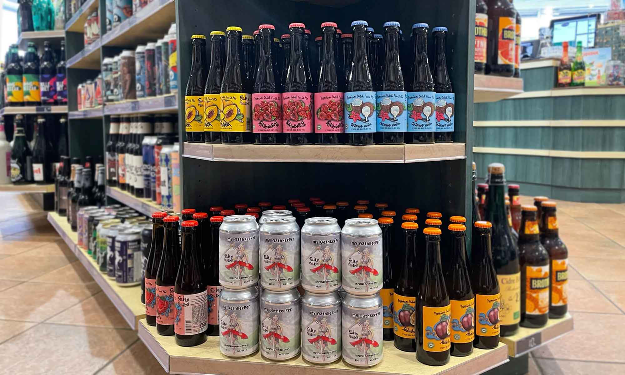Bottles and cans of beer on Slijterij van Oeveren shelves