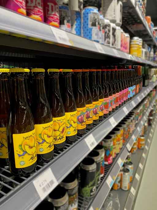 Row of beer bottles on a beer store shelf