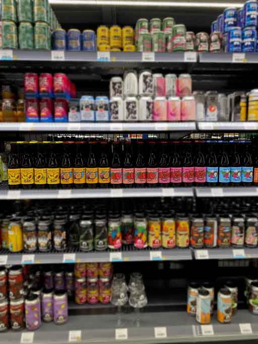 Row of beer bottles on a beer store shelf