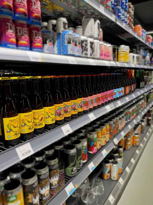 Row of beer bottles on a beer store shelf